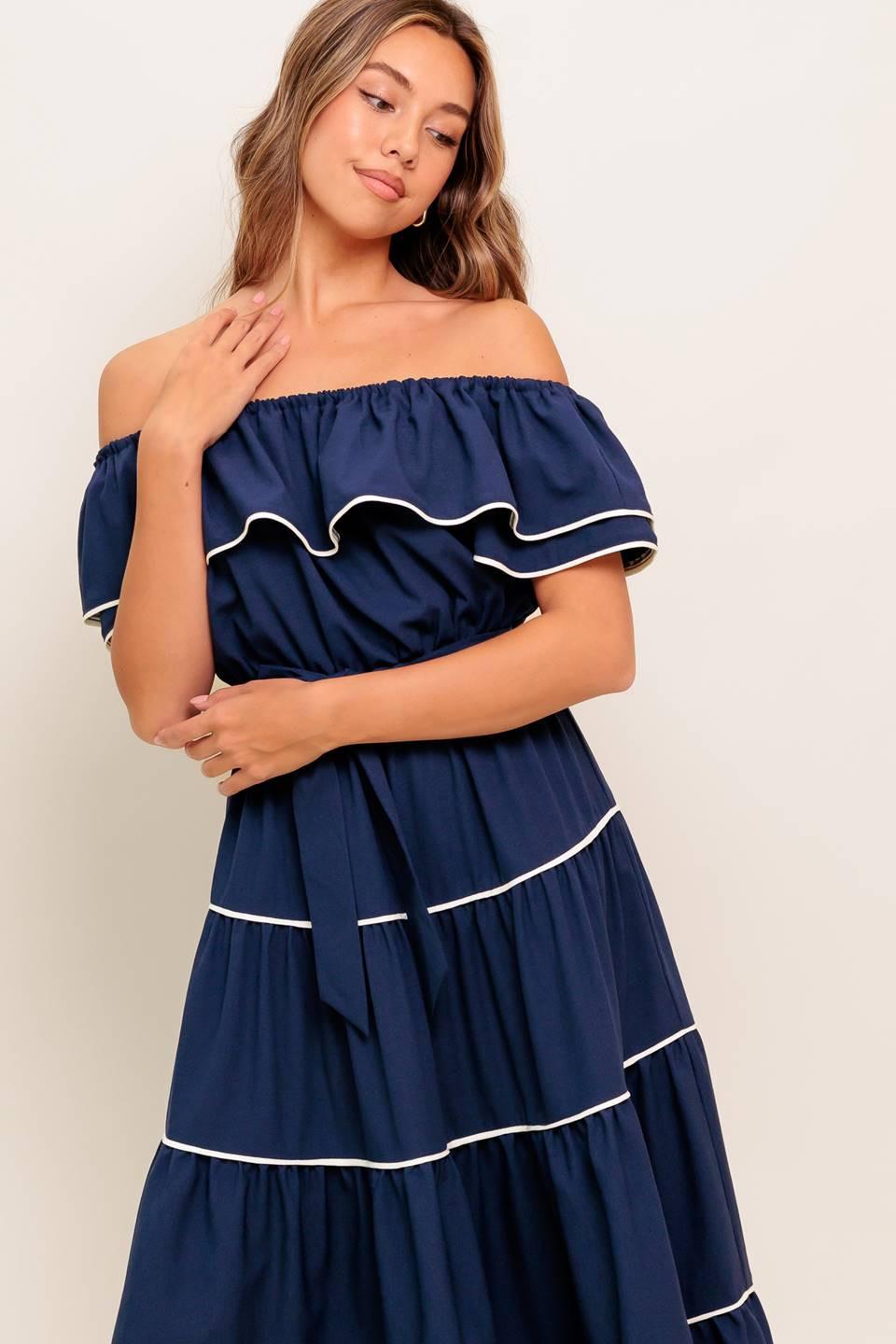 Navy off-shoulder tiered midi dress with ruffled sleeves, white trim, and bow waist.