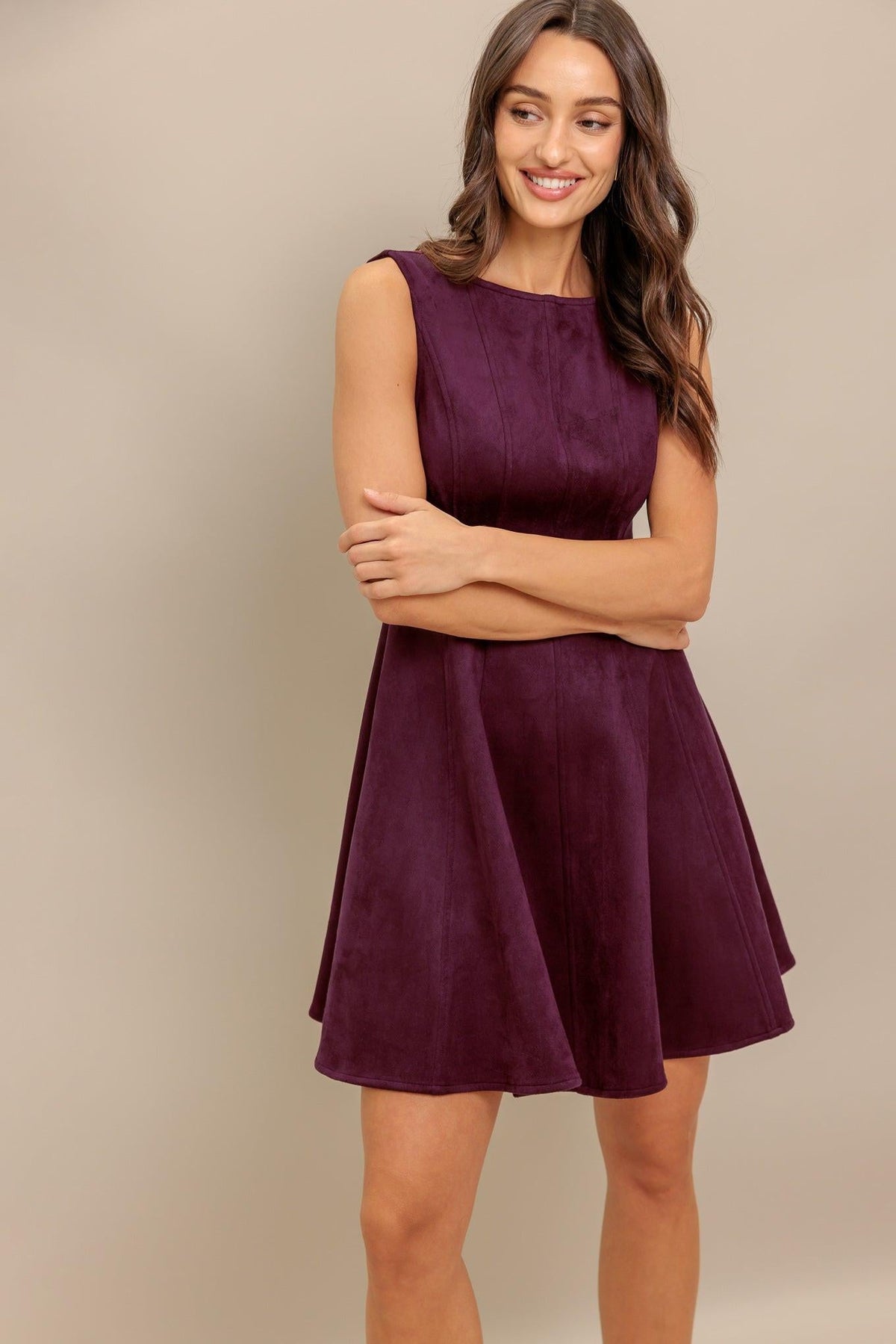 Burgundy sleeveless faux suede mini dress with round neckline and gathered flared skirt