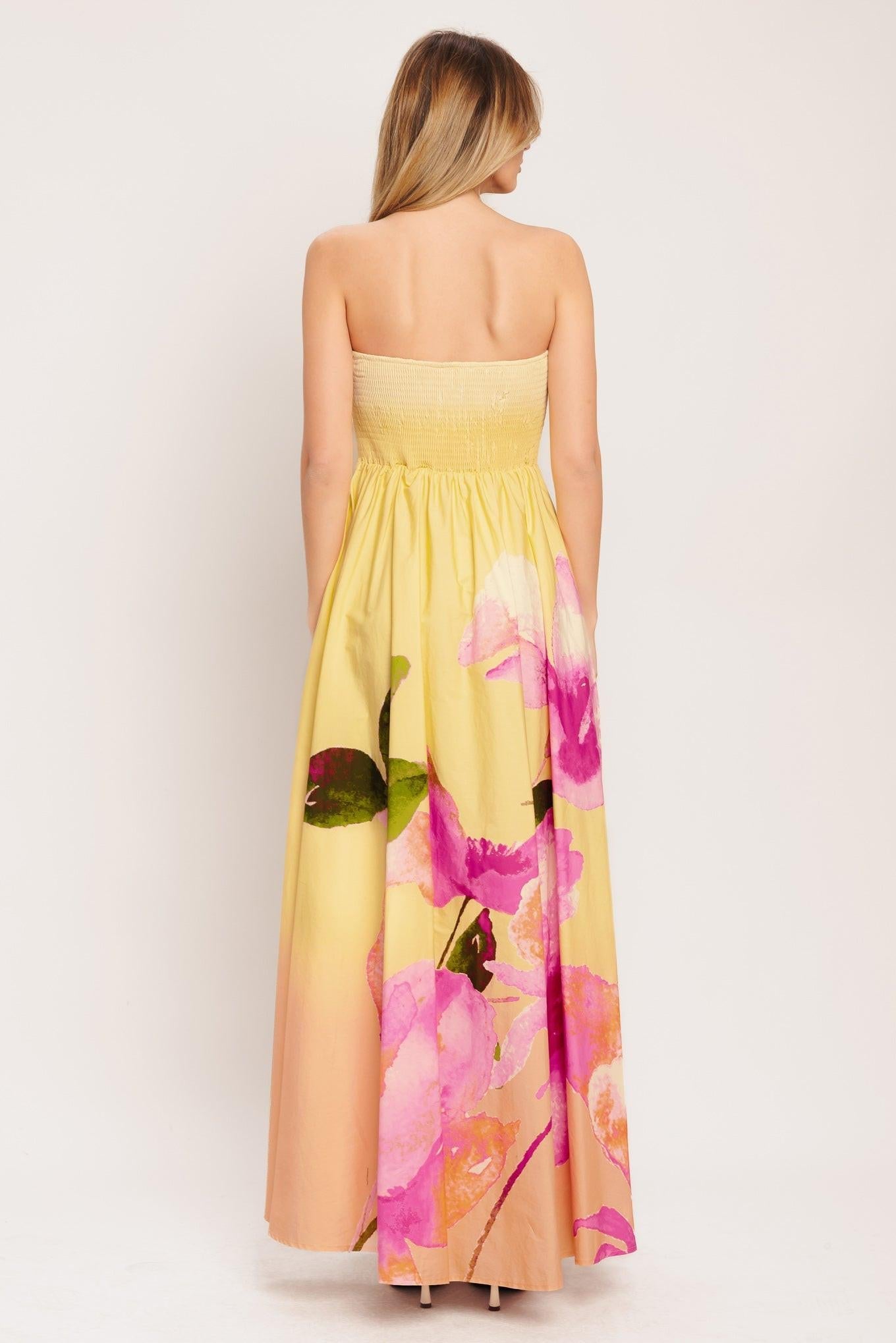 Back view of light yellow strapless maxi dress with pink floral and green leaf print