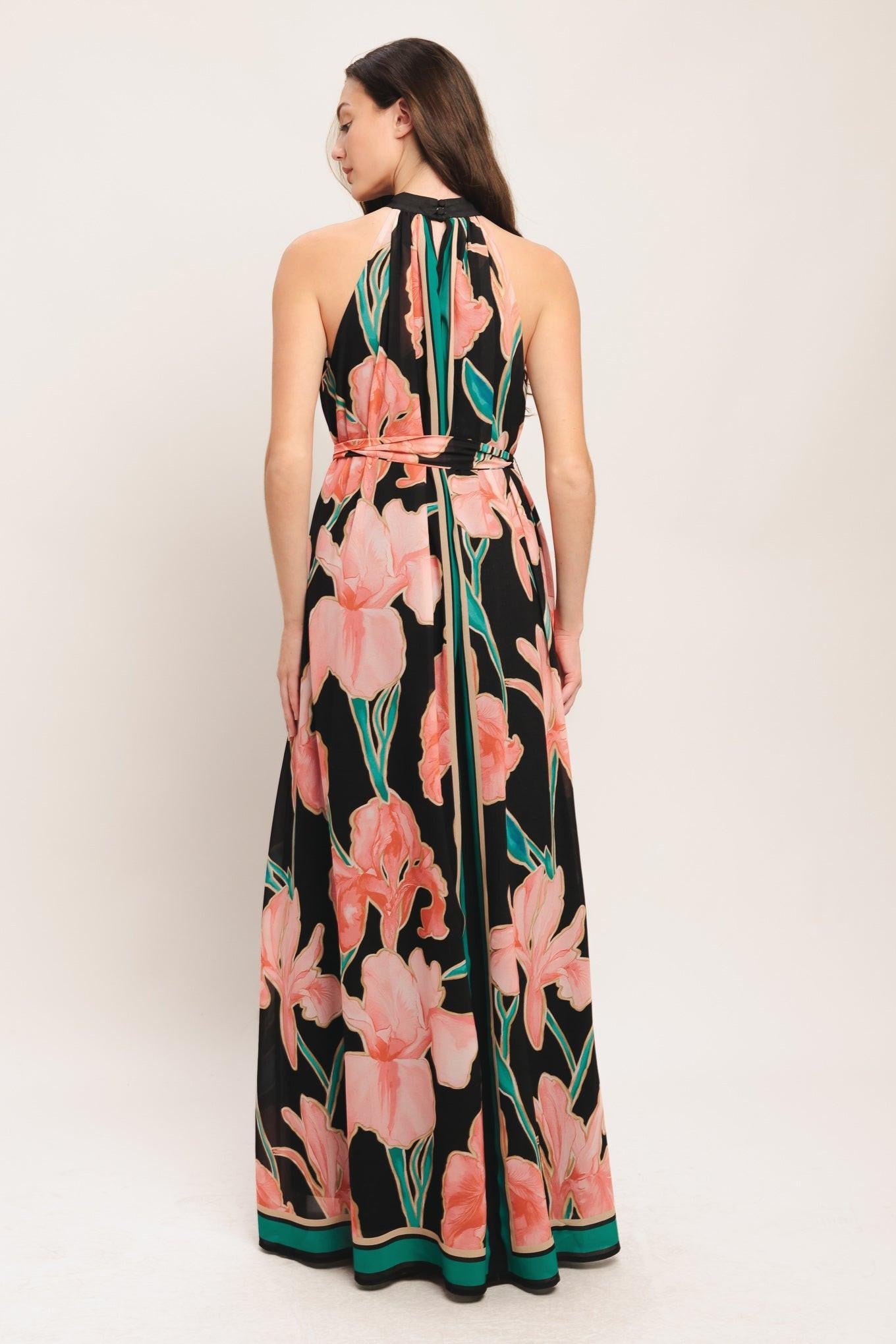 Black floral maxi dress from back view, sleeveless halter neck, tie waist, teal trim
