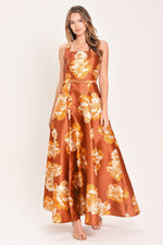Rust maxi dress with orange floral print, square neckline, sleeveless bodice, waist belt