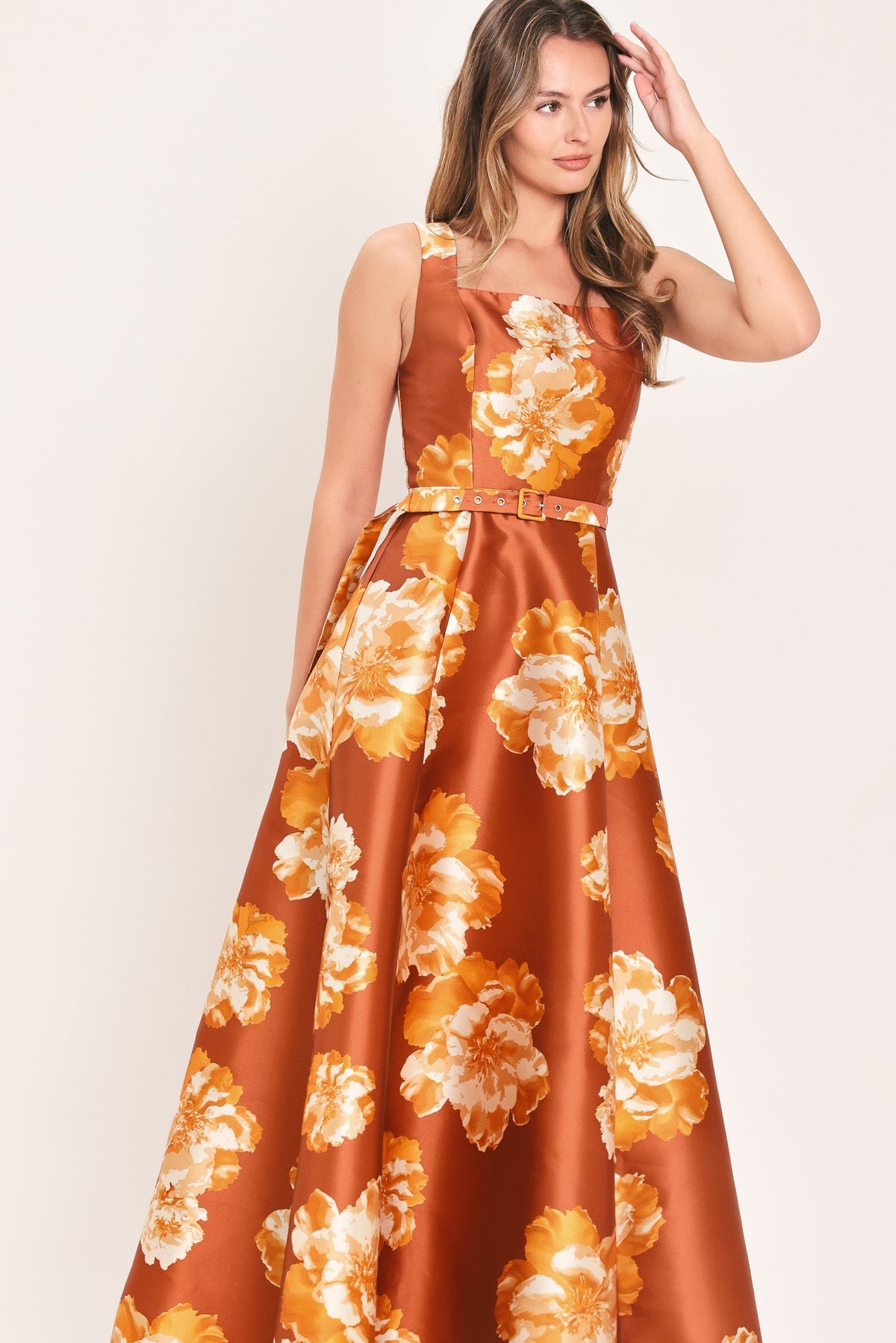 Rust maxi dress with large orange and cream floral print, fitted waist belt, sleeveless