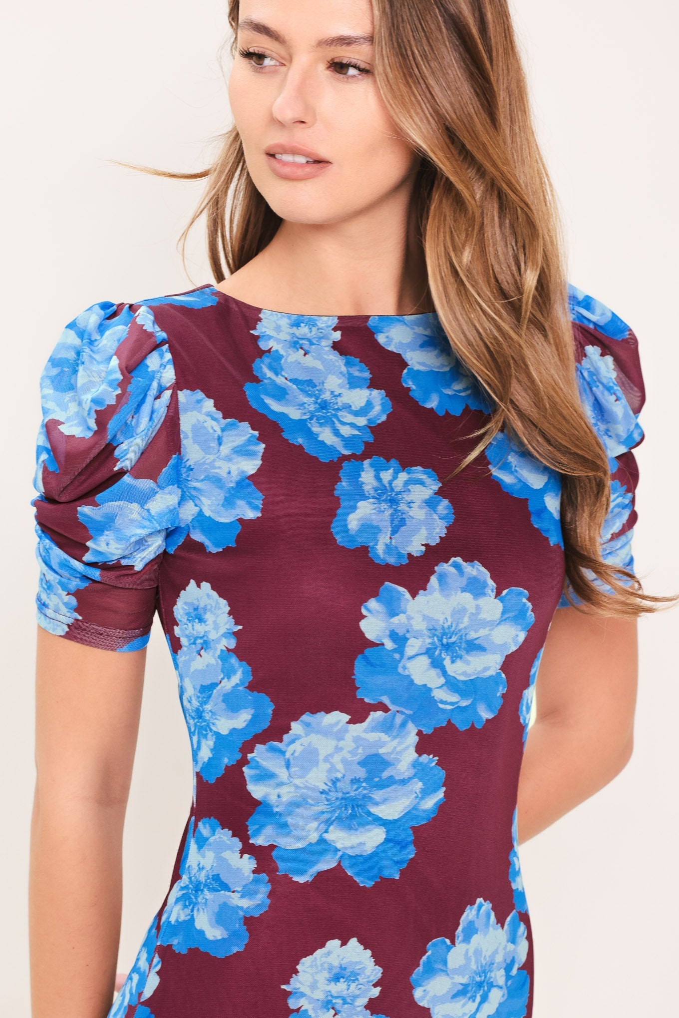 Wine floral mesh midi dress close-up showing blue flower print and puff sleeves.