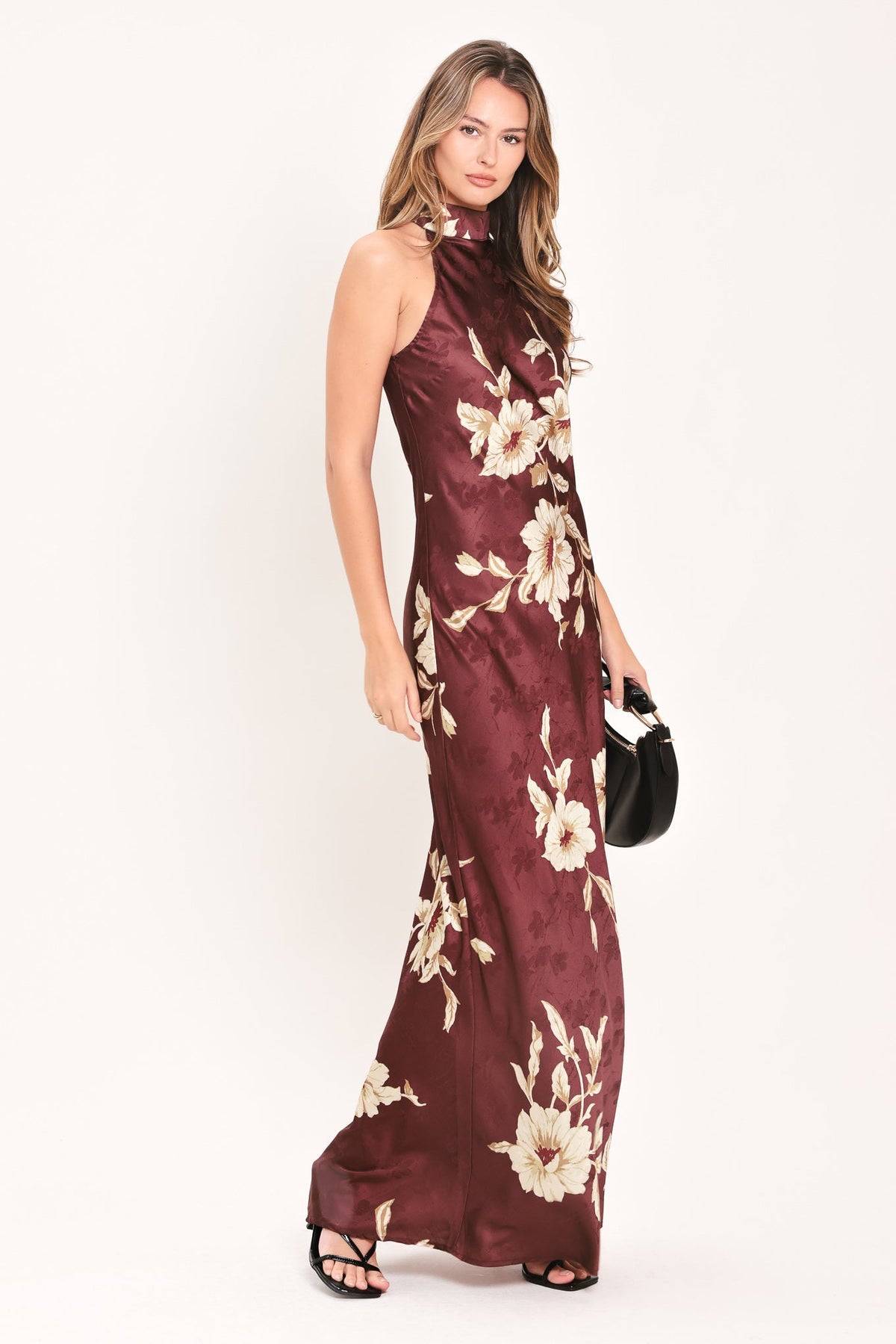 Burgundy floral sleeveless maxi dress with high neckline and long flowing skirt