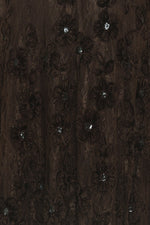 Close-up: dark brown floral embroidered lace with small crystal-like accents