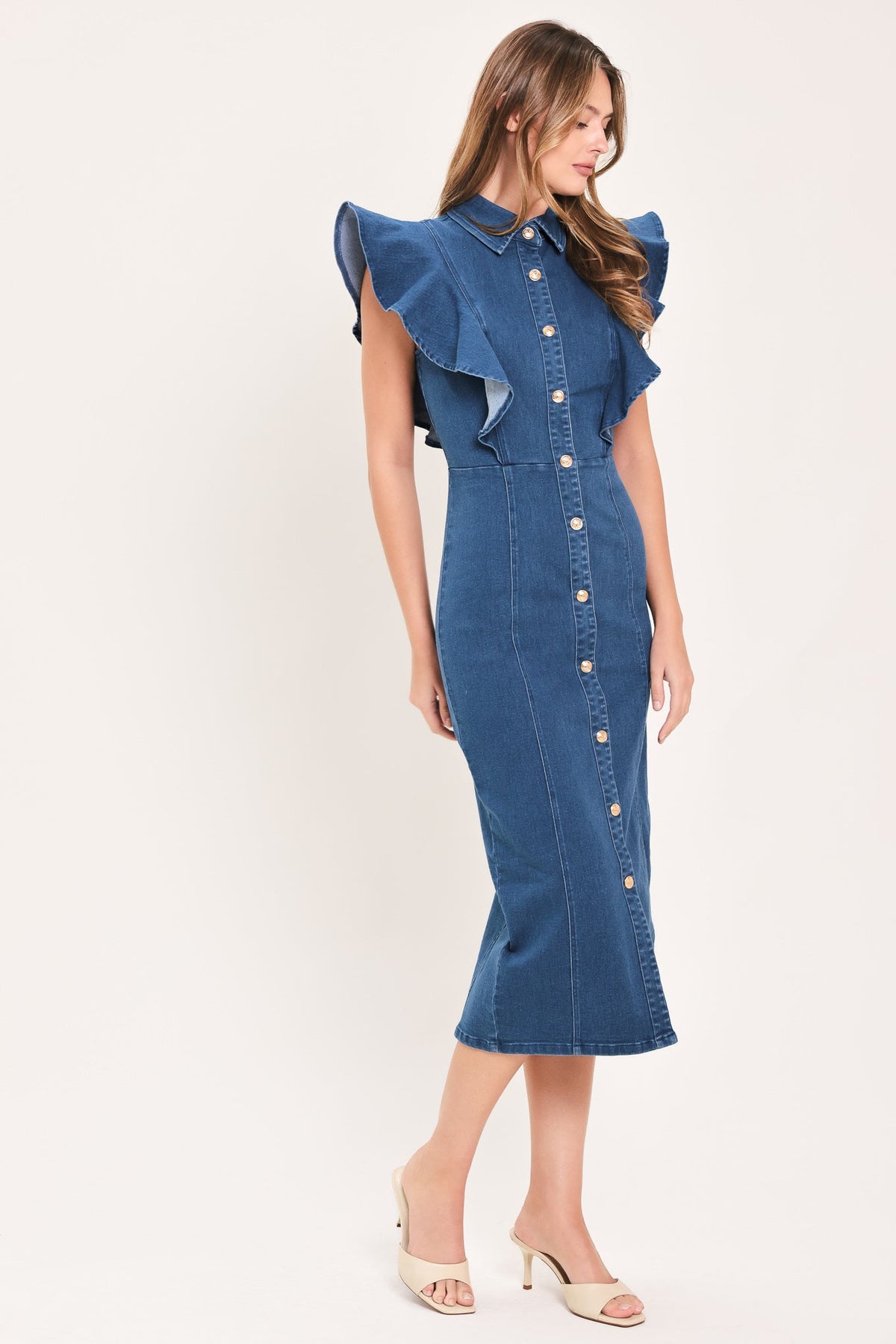 Medium indigo denim midi dress with ruffled shoulders, fitted waist, and button front