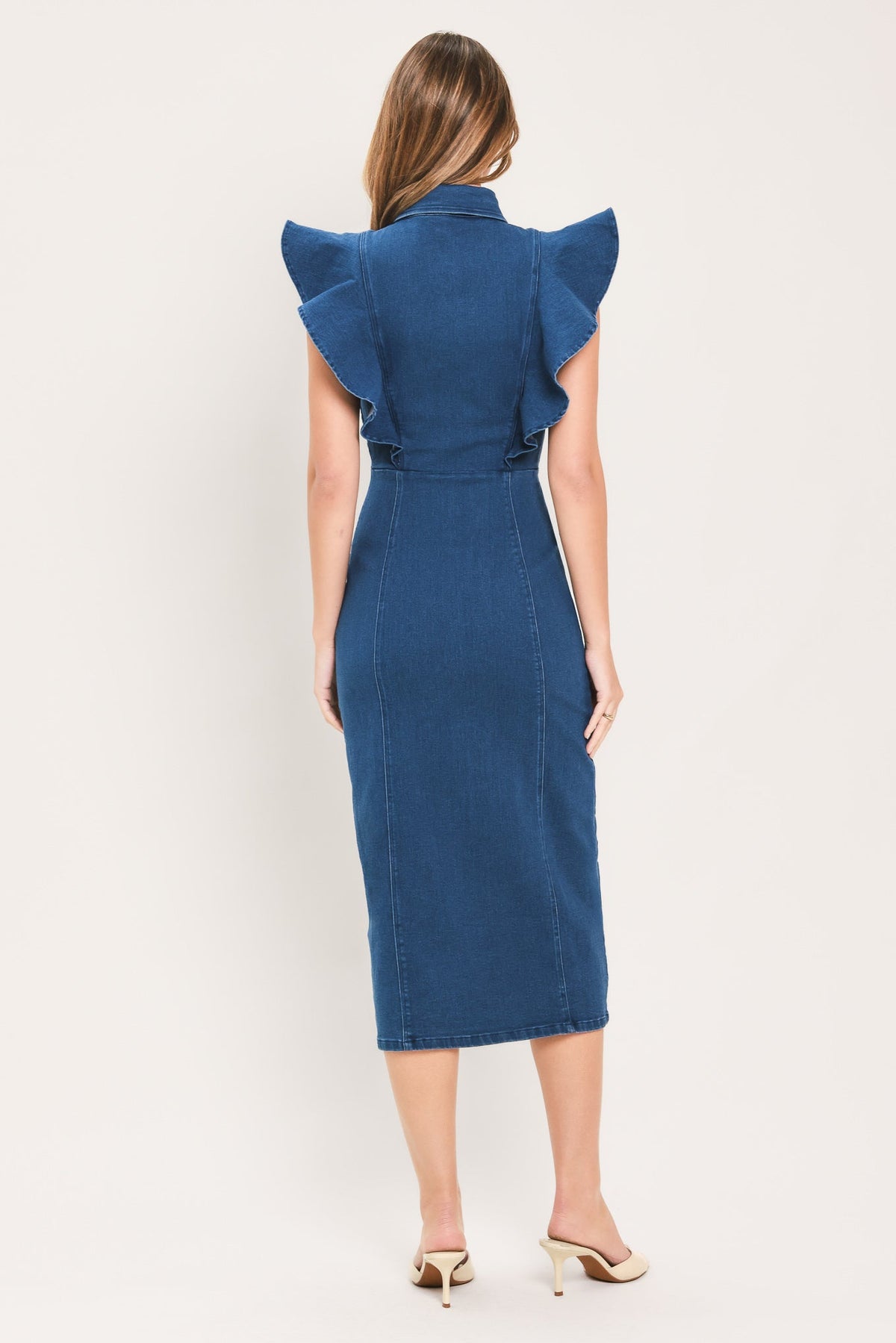 Medium indigo denim midi dress back view with ruffled shoulders and center seam