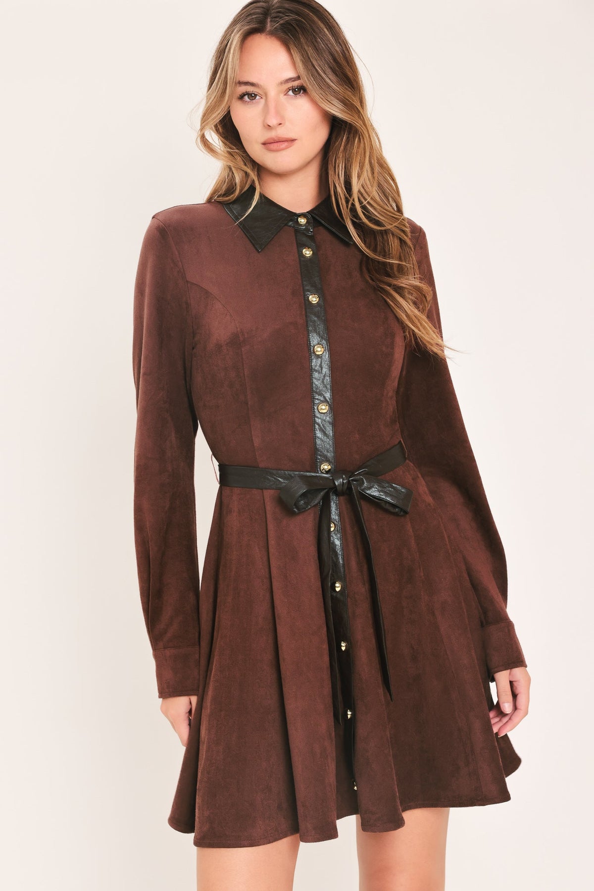 Burgundy faux suede mini dress with long sleeves, button front, and tied waist belt