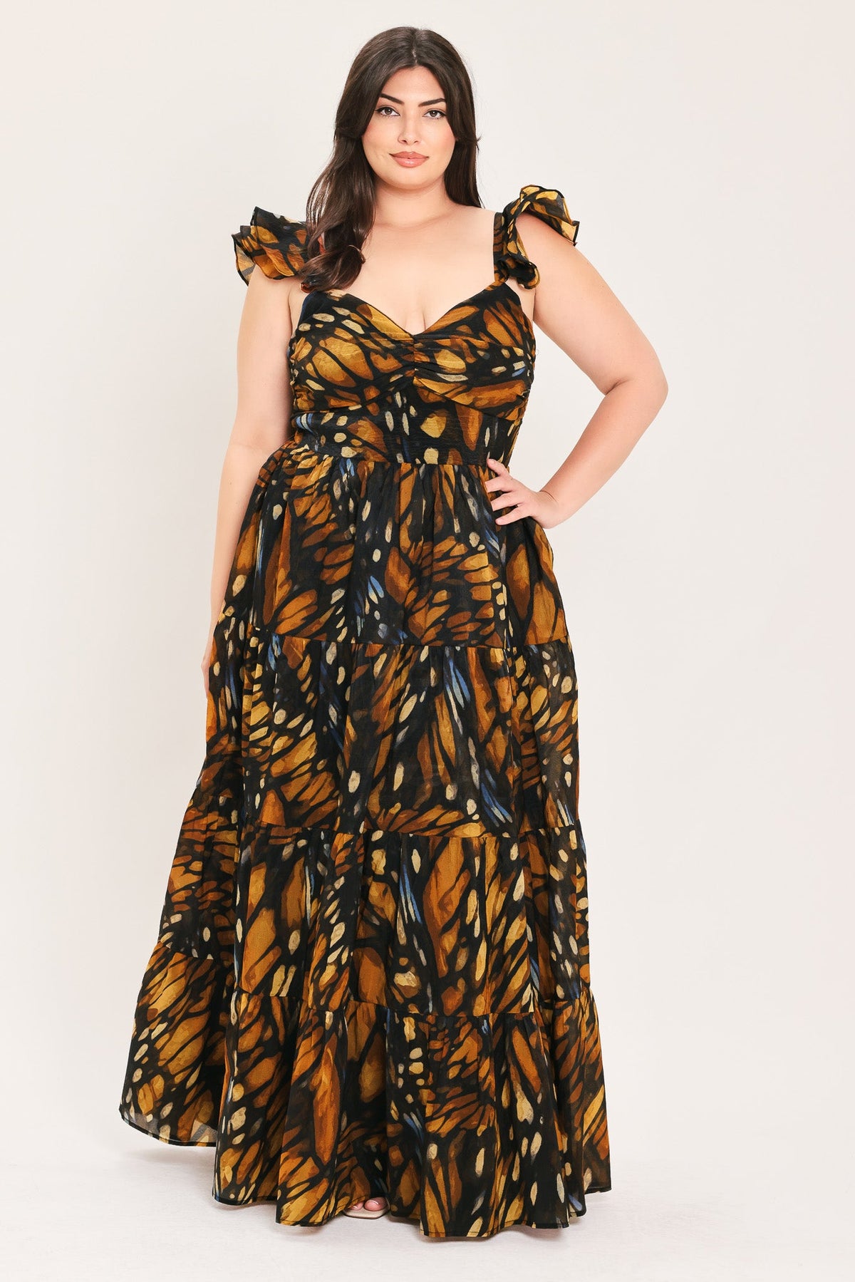 Woven maxi dress with tiered skirt, ruffled bow cap sleeves, black and amber leaf print