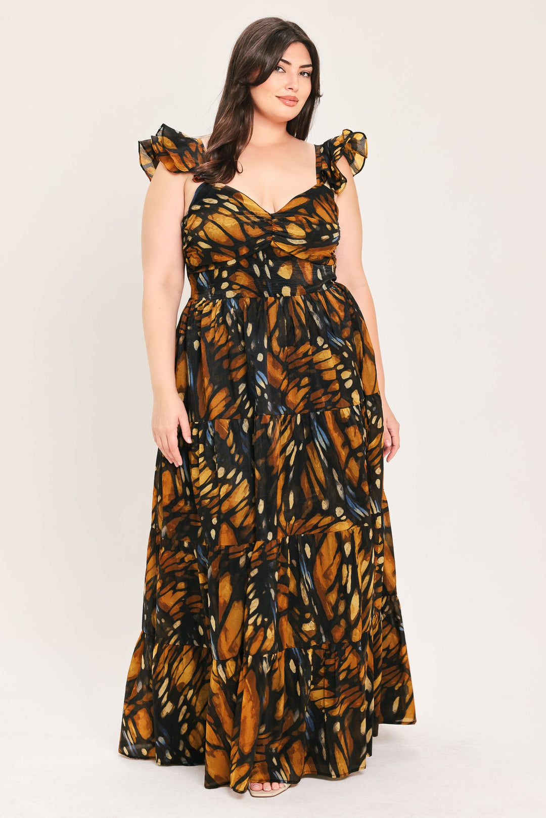 Woven maxi dress with ruffled bow cap sleeves and tiered skirt, black and amber leaf print