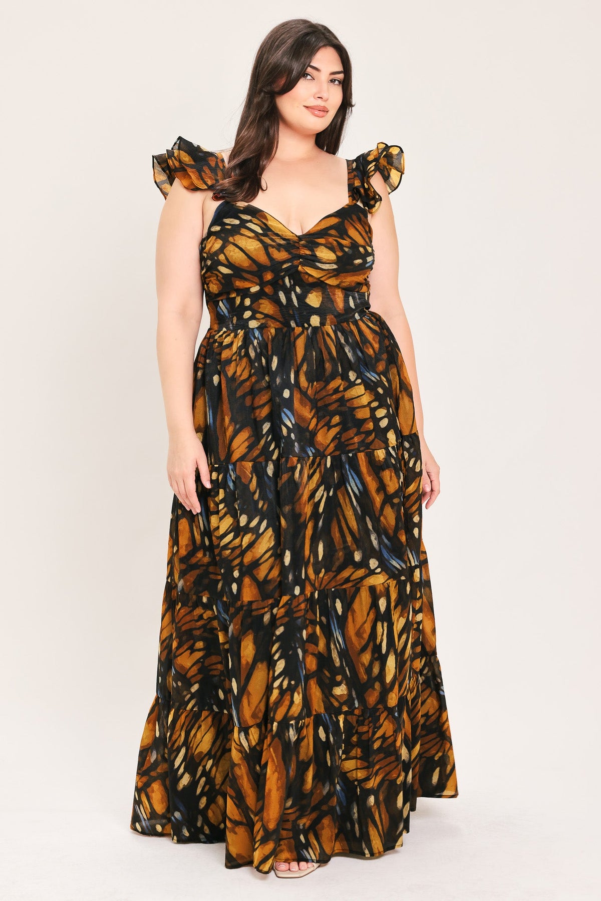 Woven maxi dress with ruffled bow cap sleeves and tiered skirt, black and amber leaf print