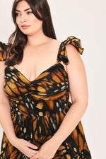 Woven maxi dress with scoop neckline, ruffled bow straps, black and amber leaf print