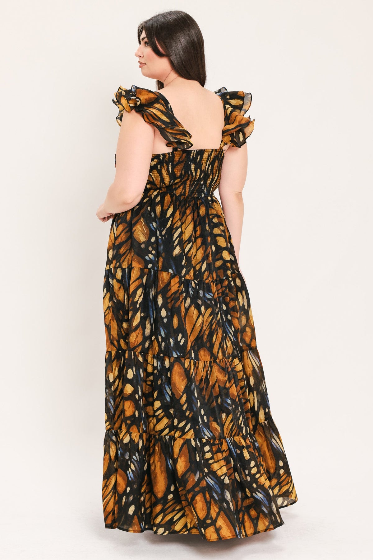 Woven maxi dress with open back and ruffled shoulder bows, black and amber leaf print