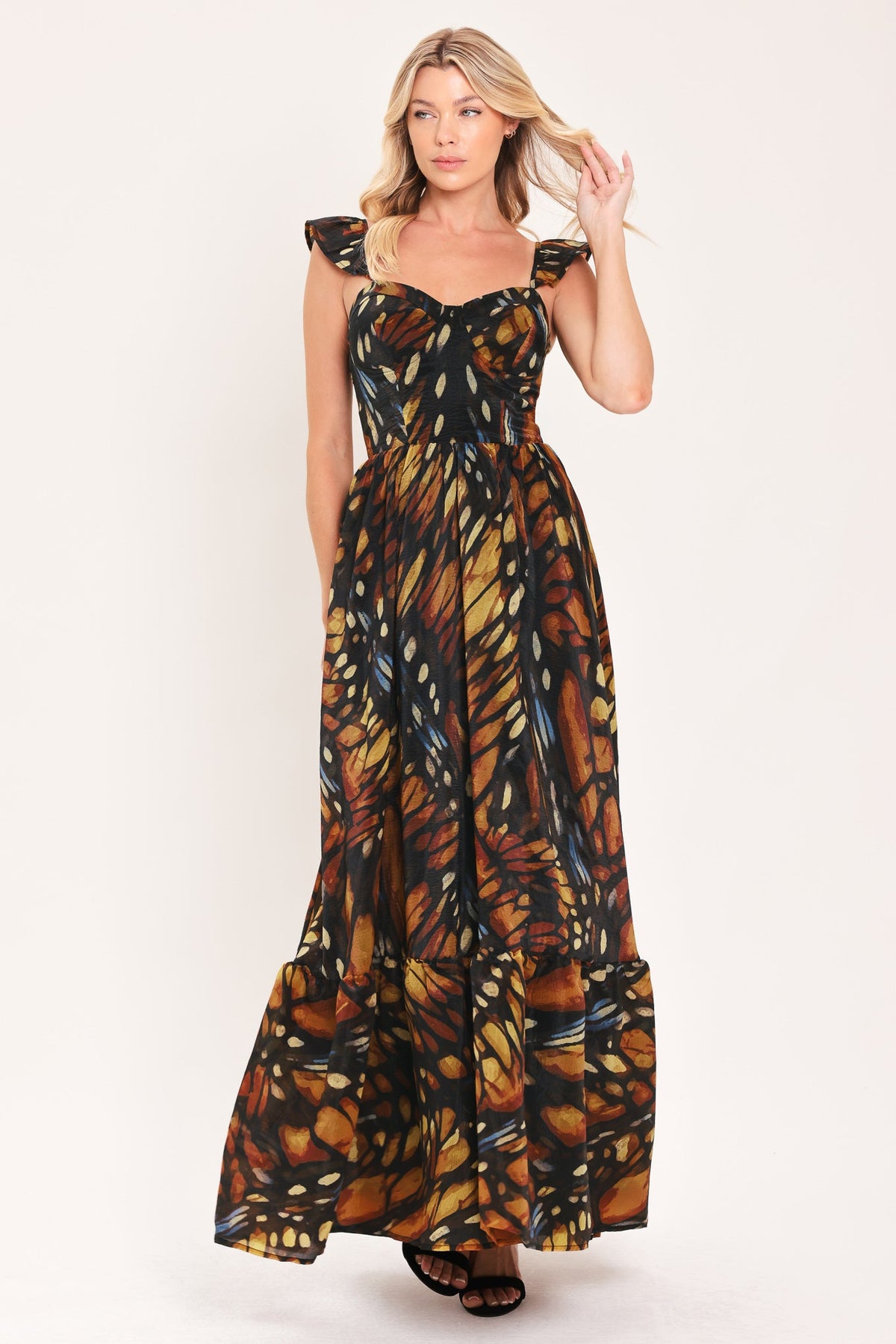 Black woven maxi dress with ruffle shoulder straps, square neckline, leaf print flowing tiers