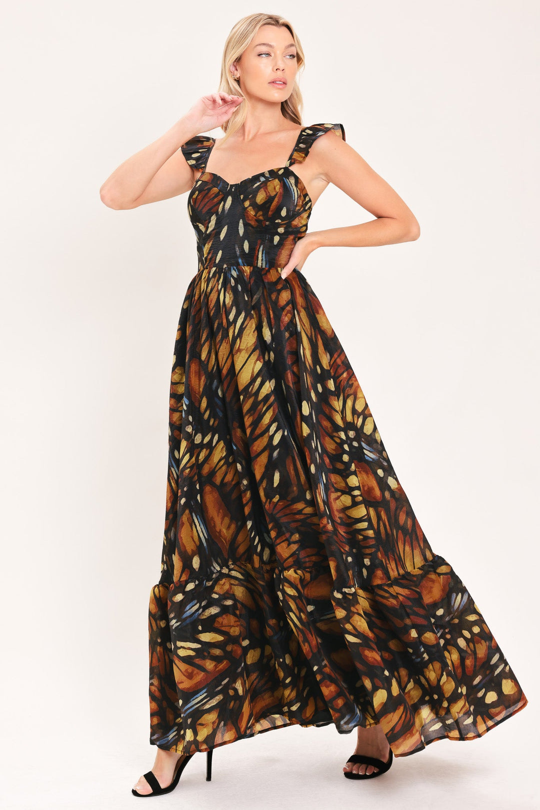 Black woven maxi dress with square neckline, gathered waist, leaf print full tiered skirt