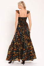 Back view of black leaf-print woven maxi dress with tiered skirt and gathered waist