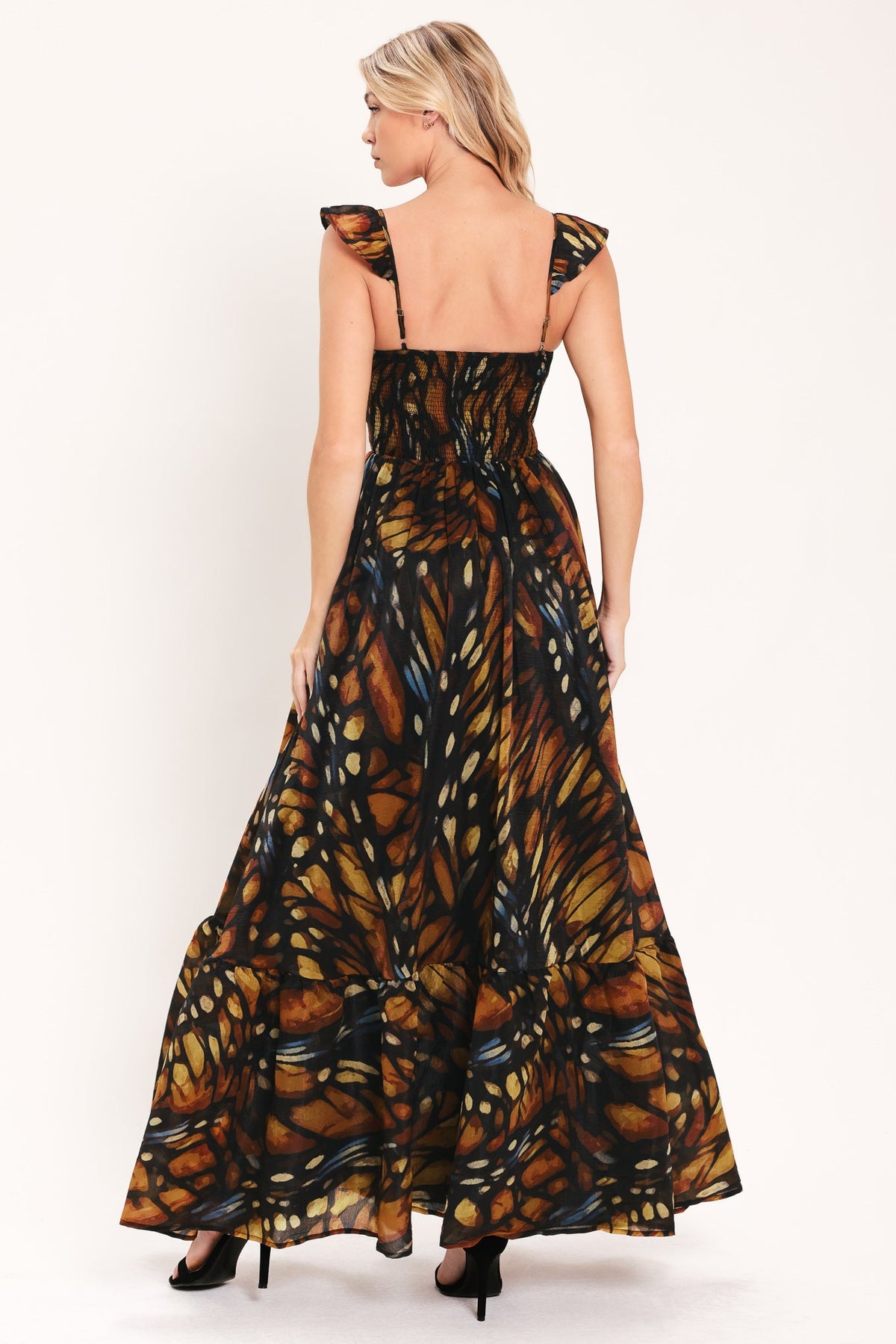 Back view of black leaf-print woven maxi dress with tiered skirt and gathered waist