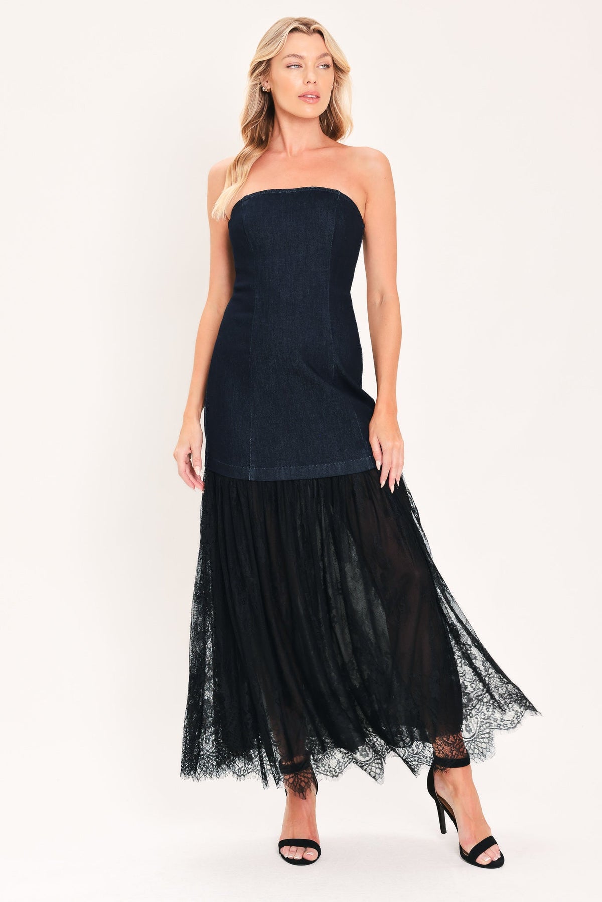 Dark indigo denim strapless tube dress with layered black tulle midi skirt and heels