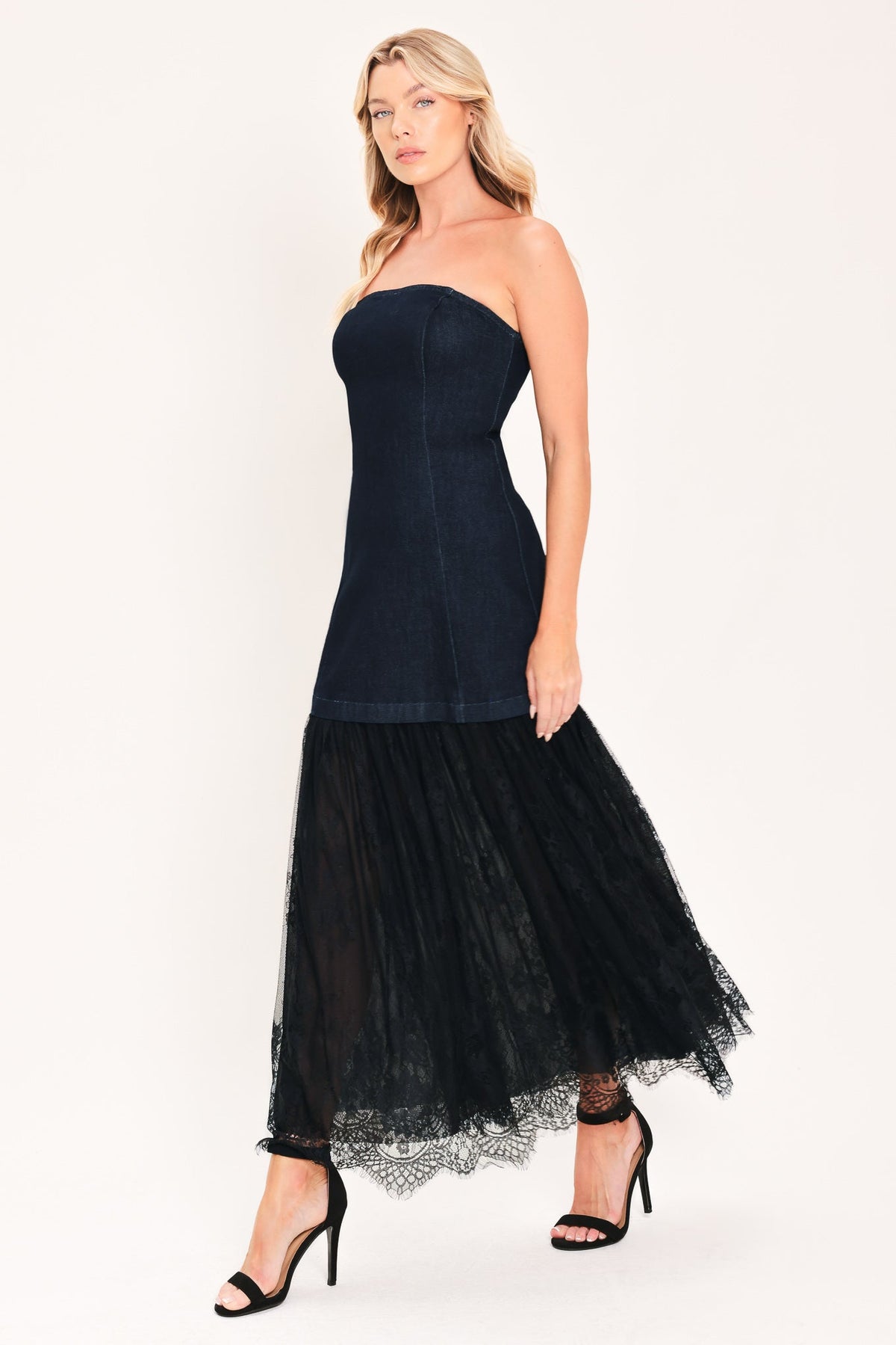 Dark indigo strapless denim tube dress with layered black tulle midi skirt, side view