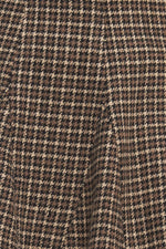 Hound flare tweed woven skirt fabric close-up, brown-and-black houndstooth weave
