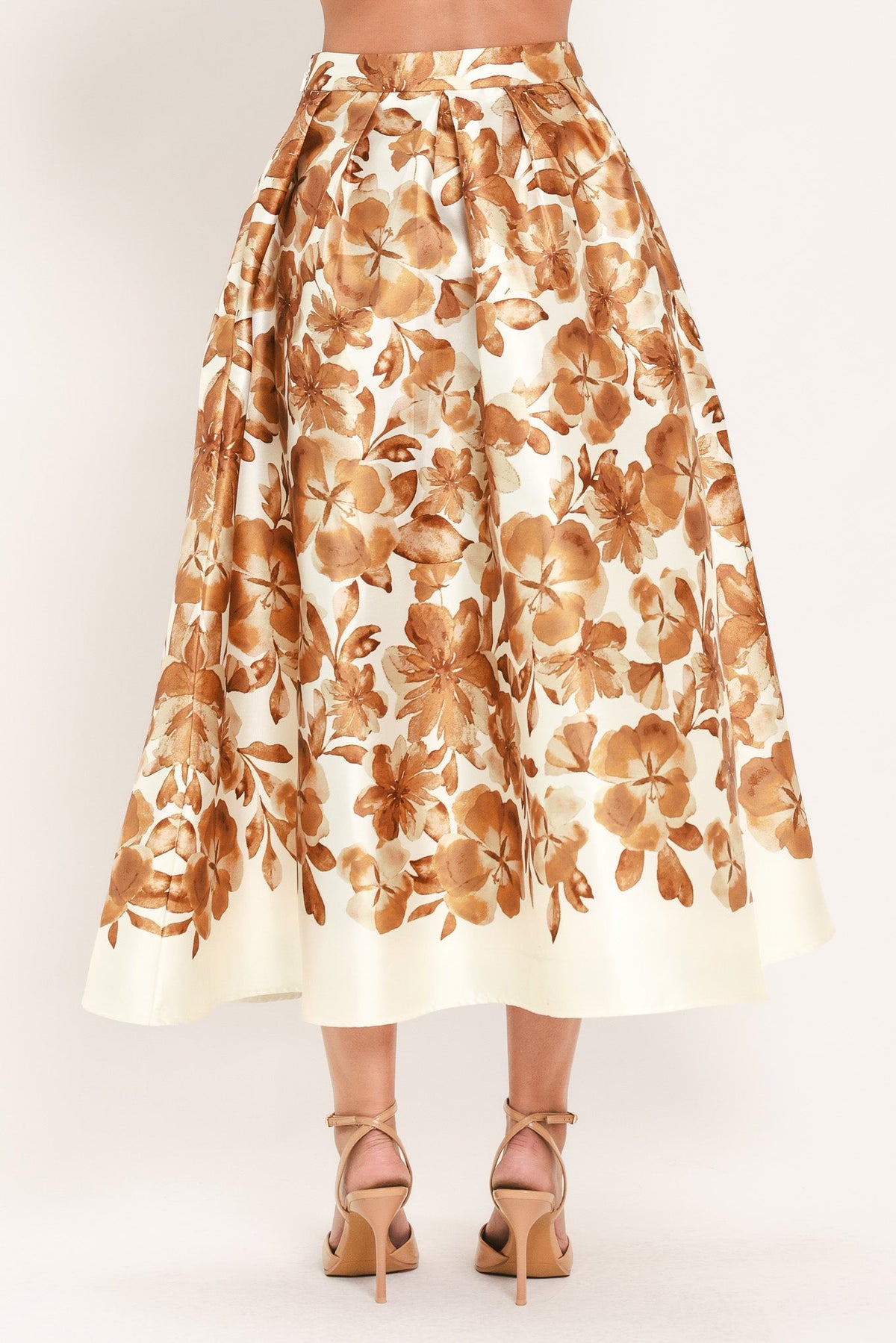 Cream midi skirt with rust floral print and gathered waistband, flowing A-line