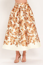 Cream midi skirt with rust floral print, gathered waistband, full skirt silhouette