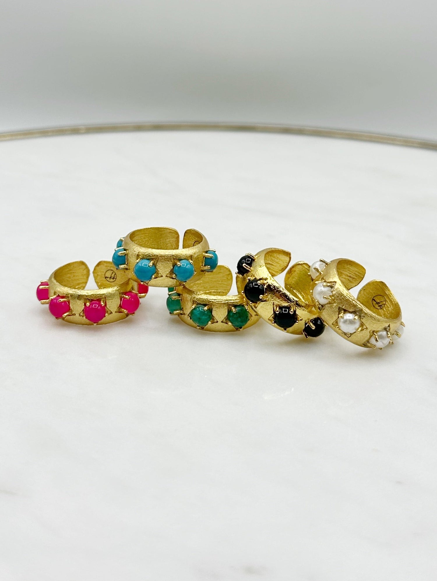 Gold-tone cuff ring with turquoise and pink jewel insets