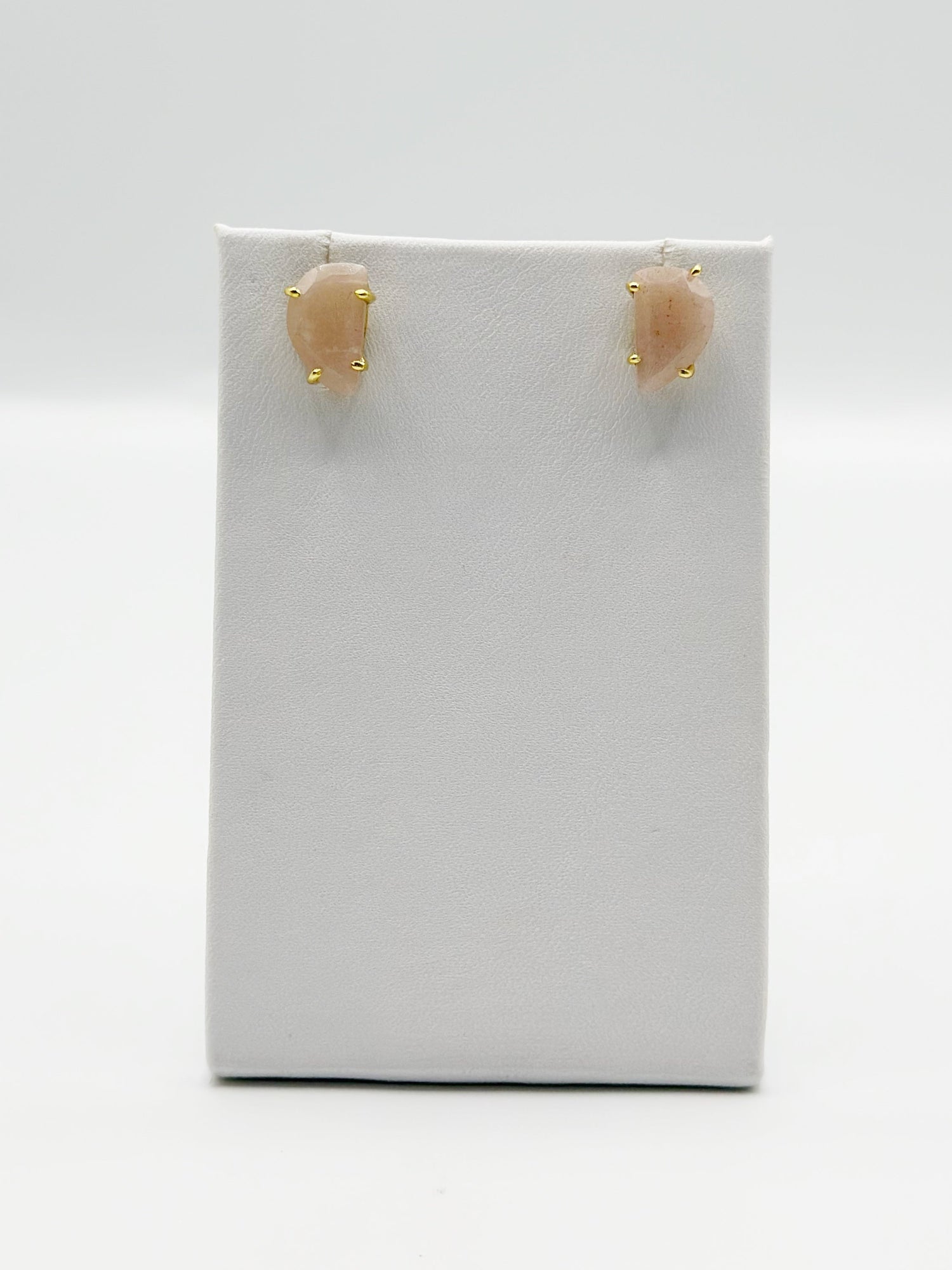 Peach moonstone stud earrings, oval stones in gold-tone settings