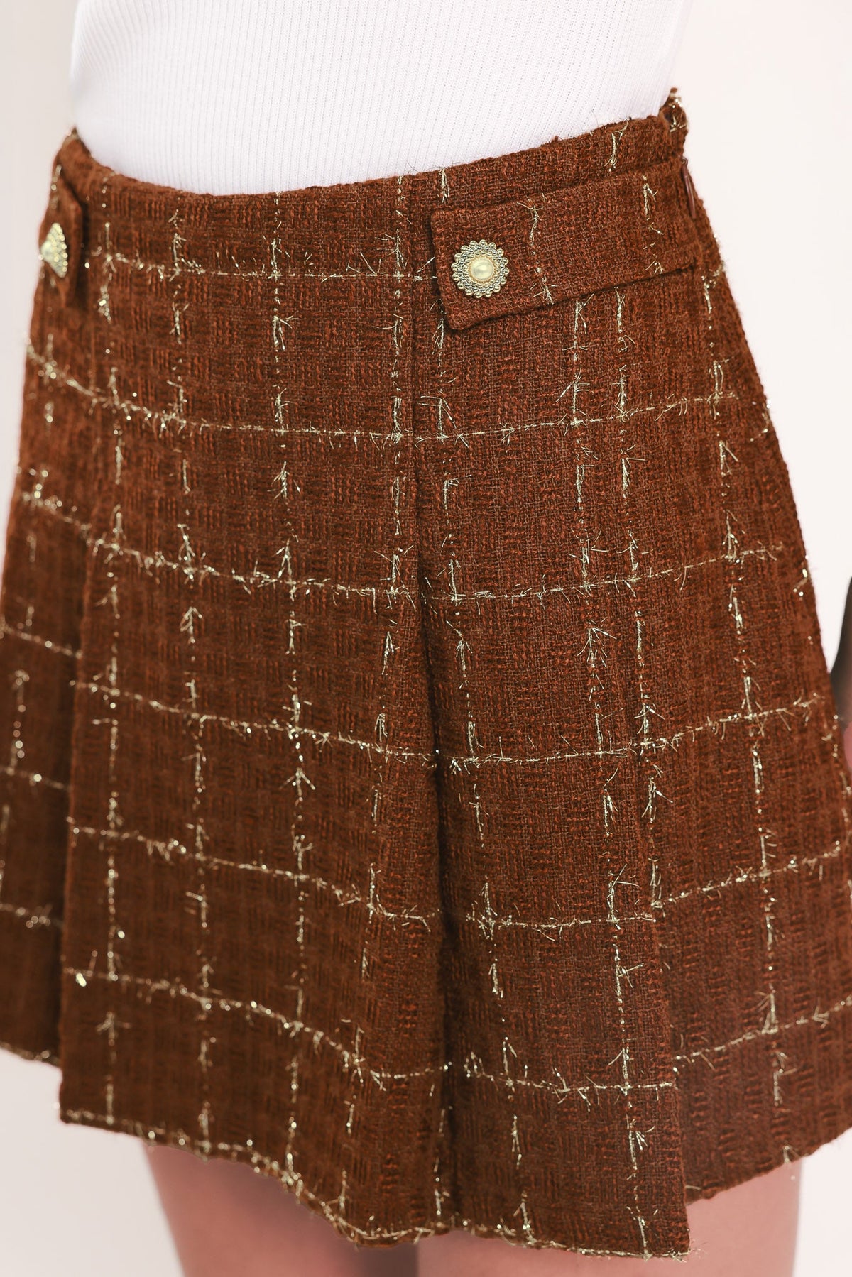 Rust plaid tweed skort with gold-toned button detail and stitched grid texture