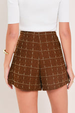 Rust plaid tweed skort with front button placket and pleated shorts silhouette