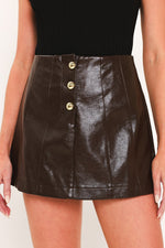 Dark brown faux leather skort with gold button front and stitched panels