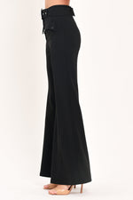 Black wide-leg pants from the back with belt loops, pocket, and flared hem
