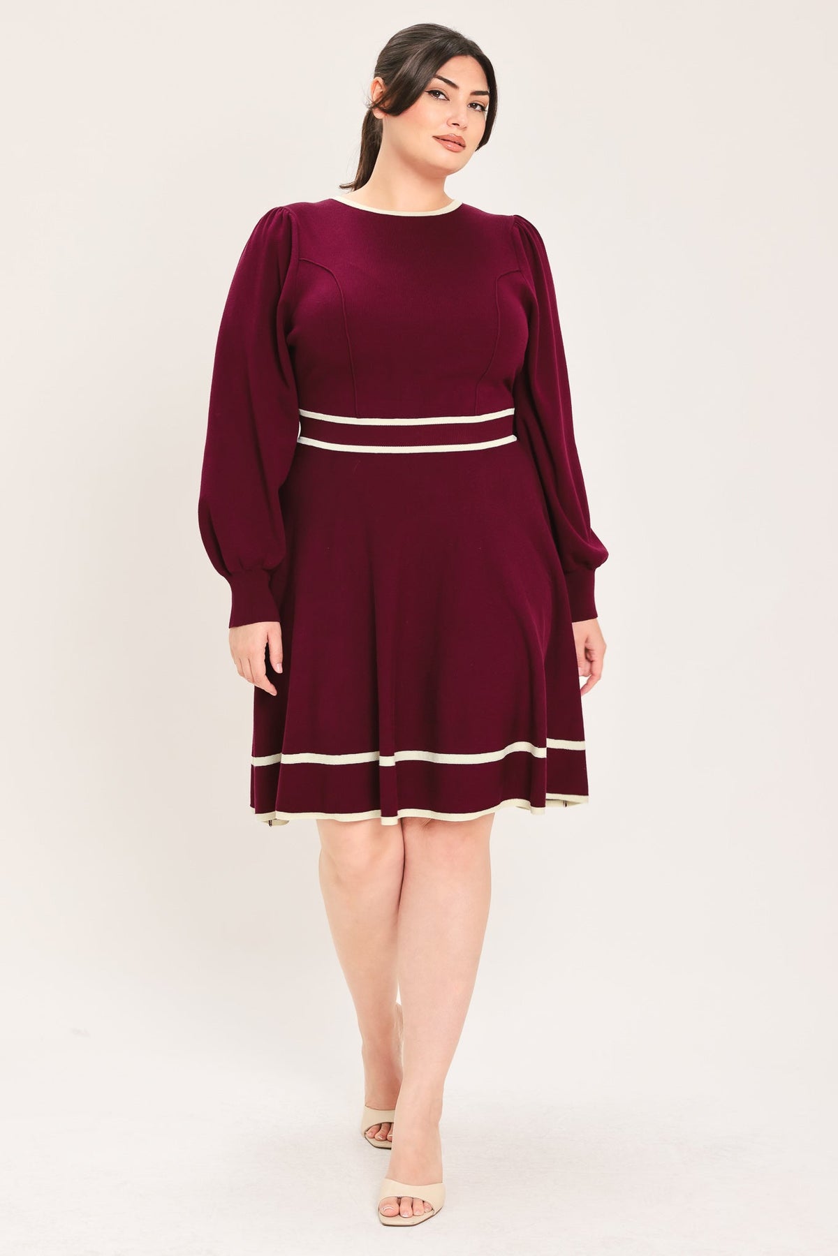 Wine knit mini dress with long puff sleeves, crew neck, and light stripe waistband.