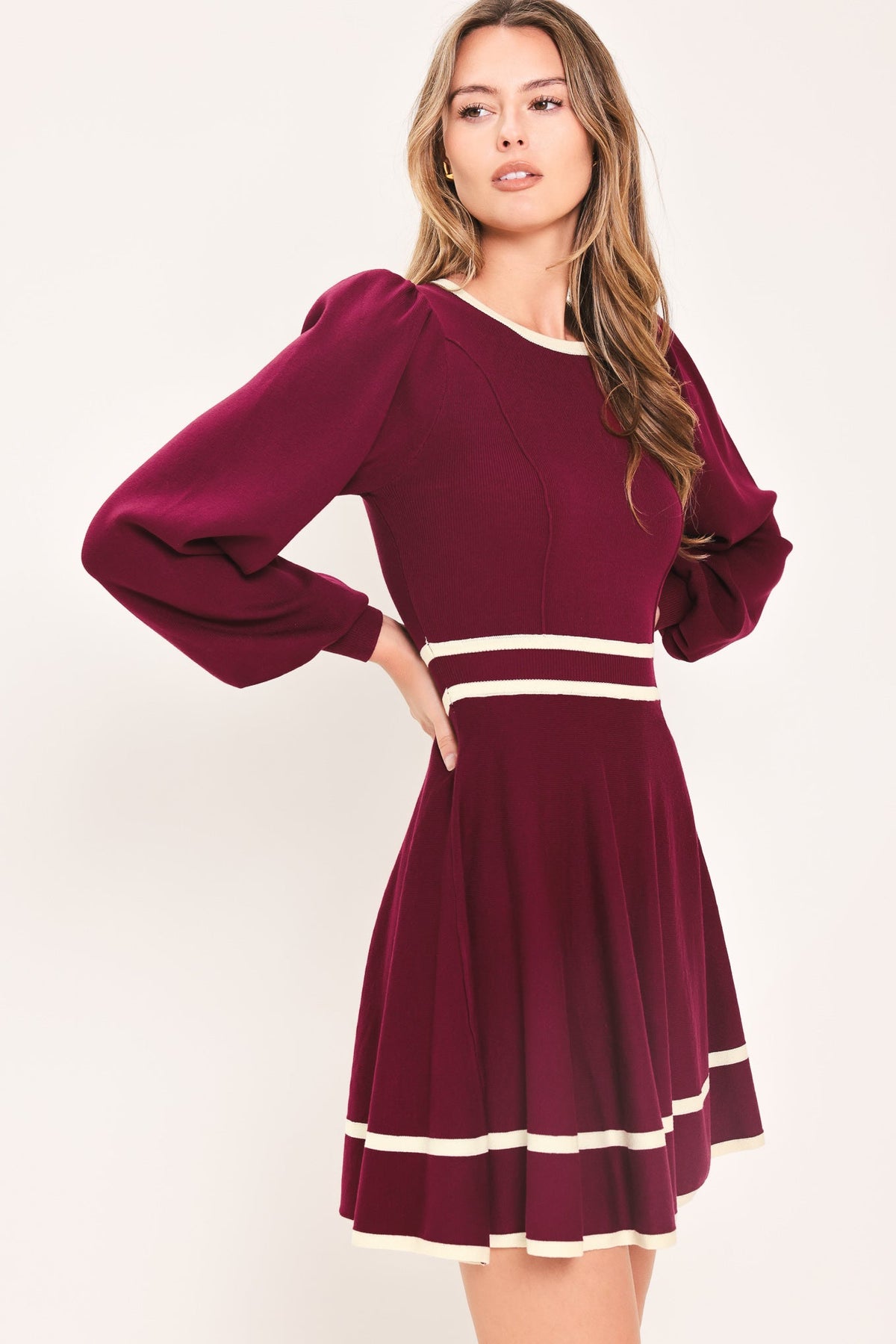 Wine sweater mini dress with ivory stripe waistband and hem, puff sleeves and flared skirt