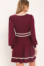 Back view of wine sweater mini dress with ivory stripe hem and three-quarter puff sleeves