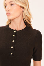 Close-up: dark brown knit sweater top with short sleeves and gold henley buttons