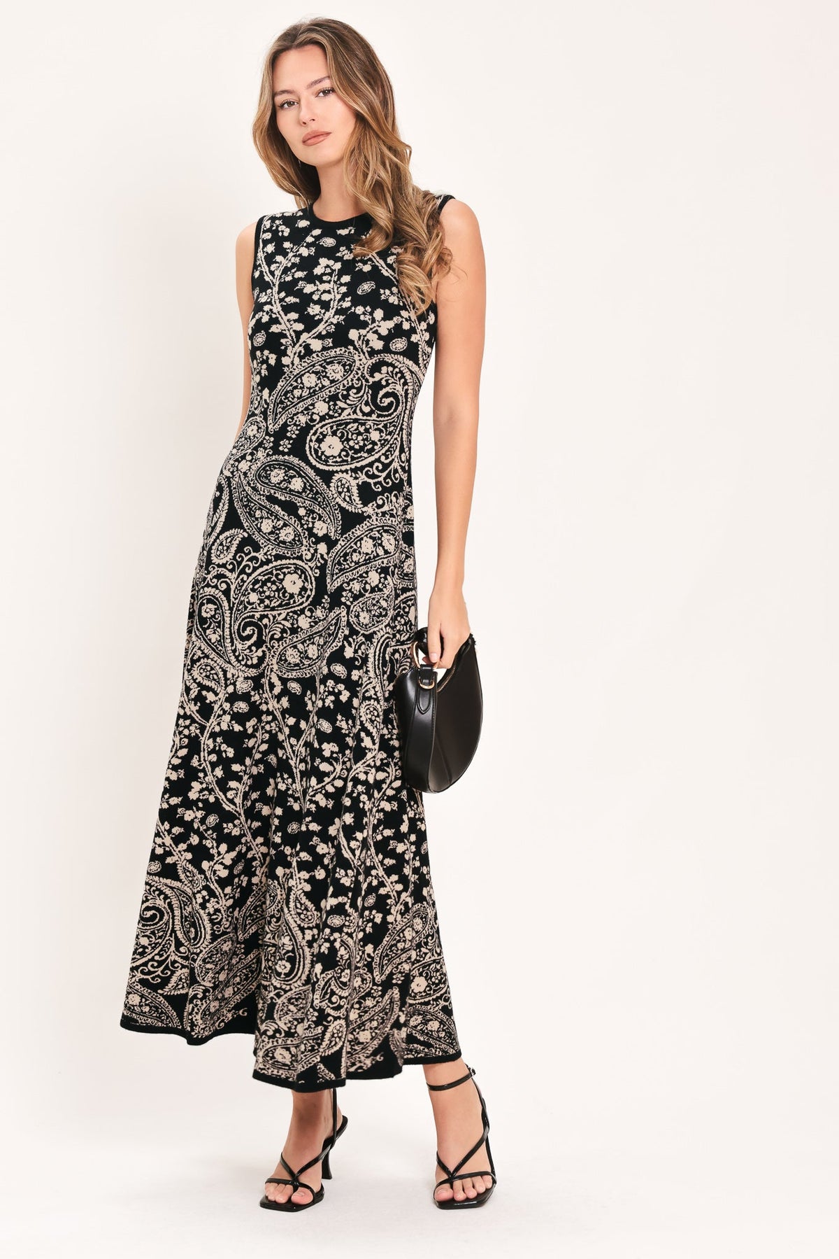 Black sleeveless midi sweater dress with ornate paisley jacquard pattern