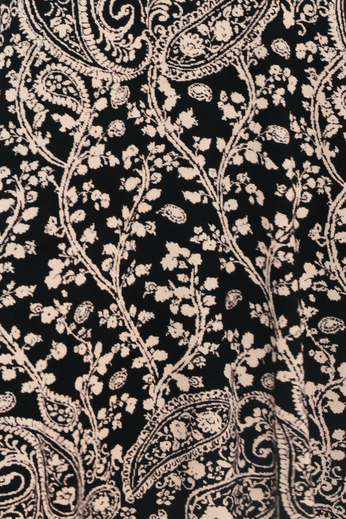 Close-up of black-and-cream paisley jacquard pattern on a sweater dress