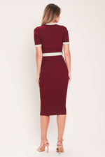 Back view of burgundy ribbed knit button-down midi dress with cream-trim sleeves and waist