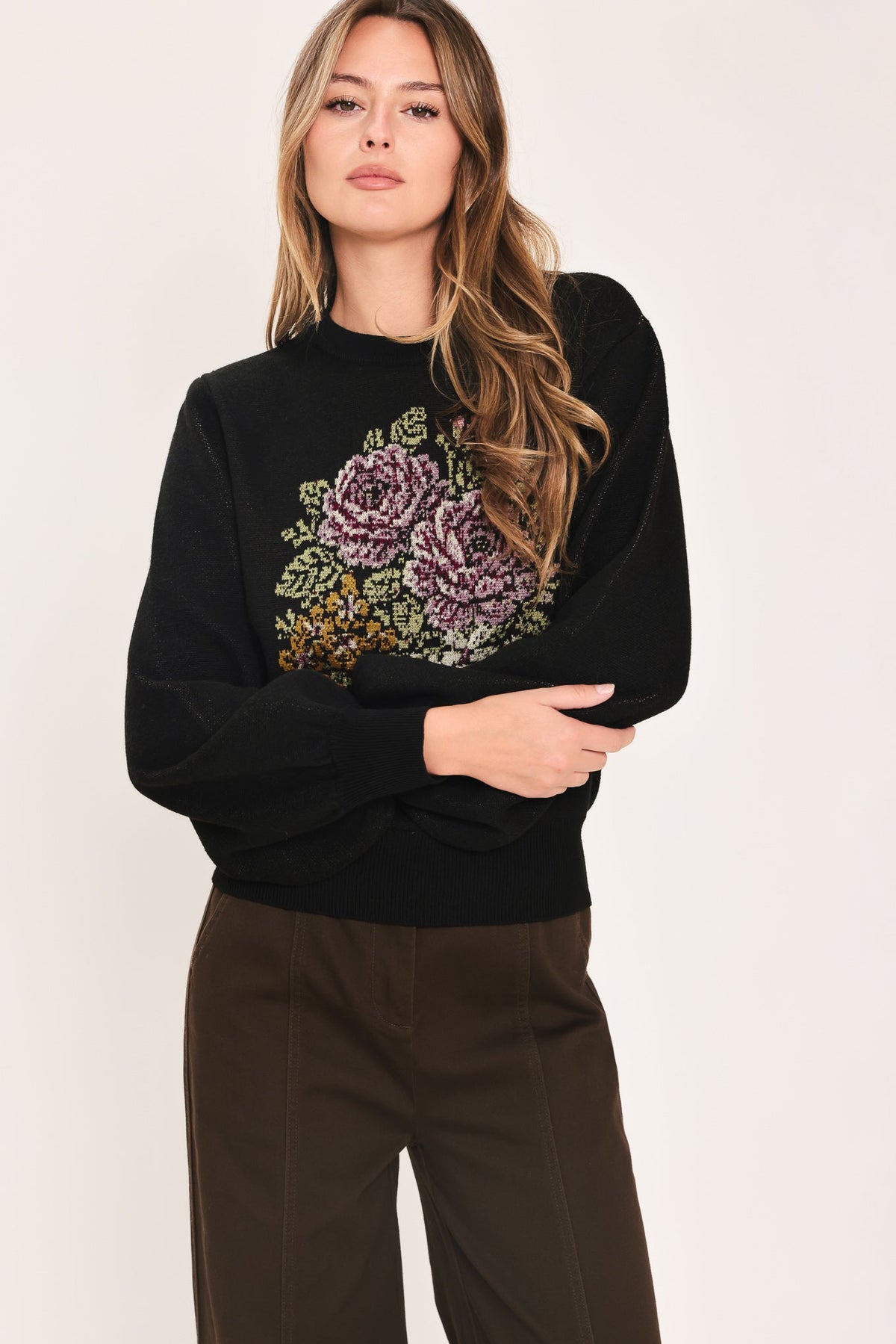 Black balloon-sleeve sweater with multicolor floral front graphic