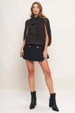 Black dot woven top with bow-tie collar and long sheer sleeves