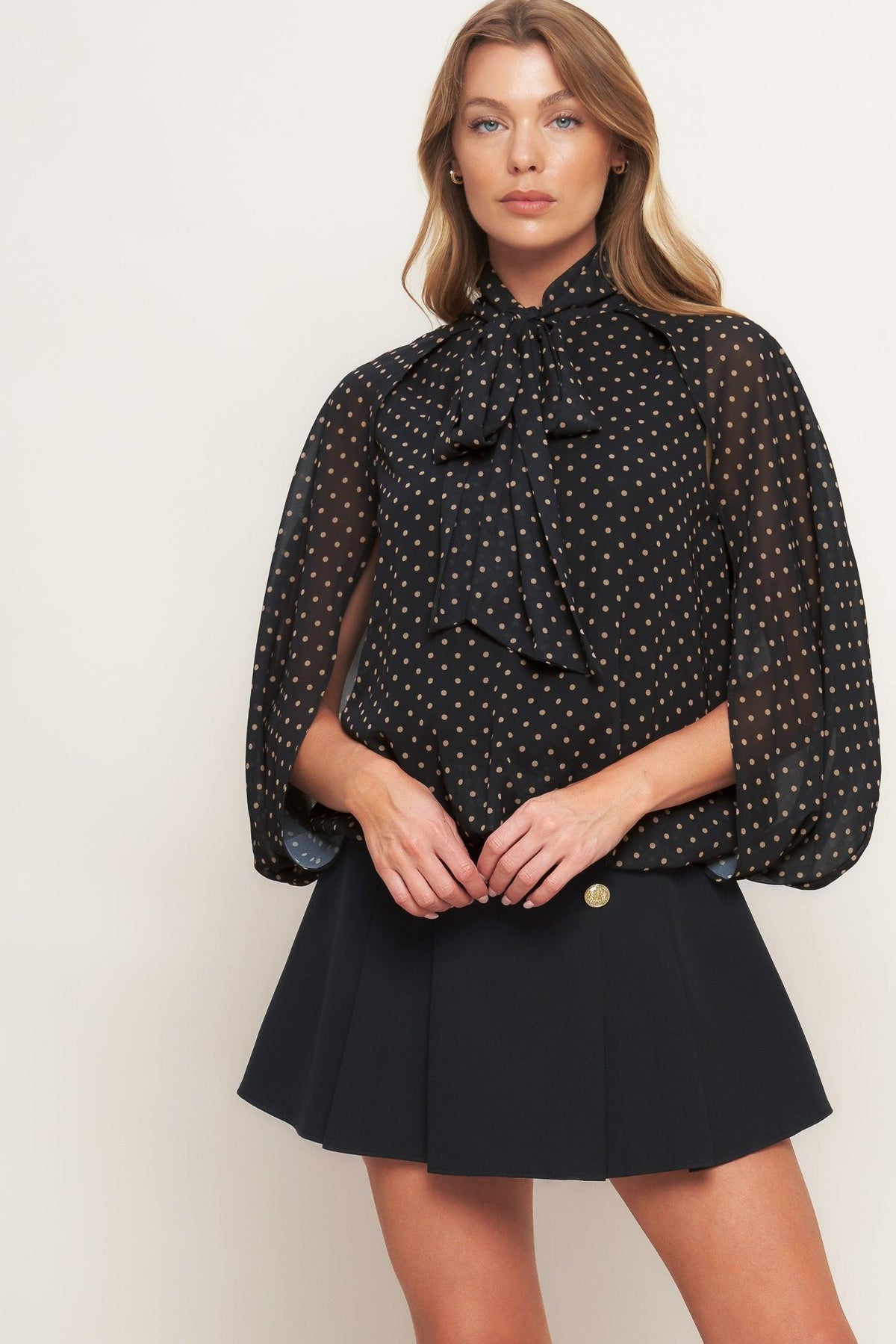 Black woven top with gold dots, bow collar and relaxed fit