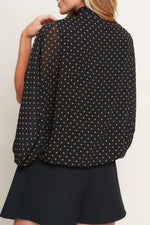 Black woven top with gold dot print, back yoke and cape-like sleeves