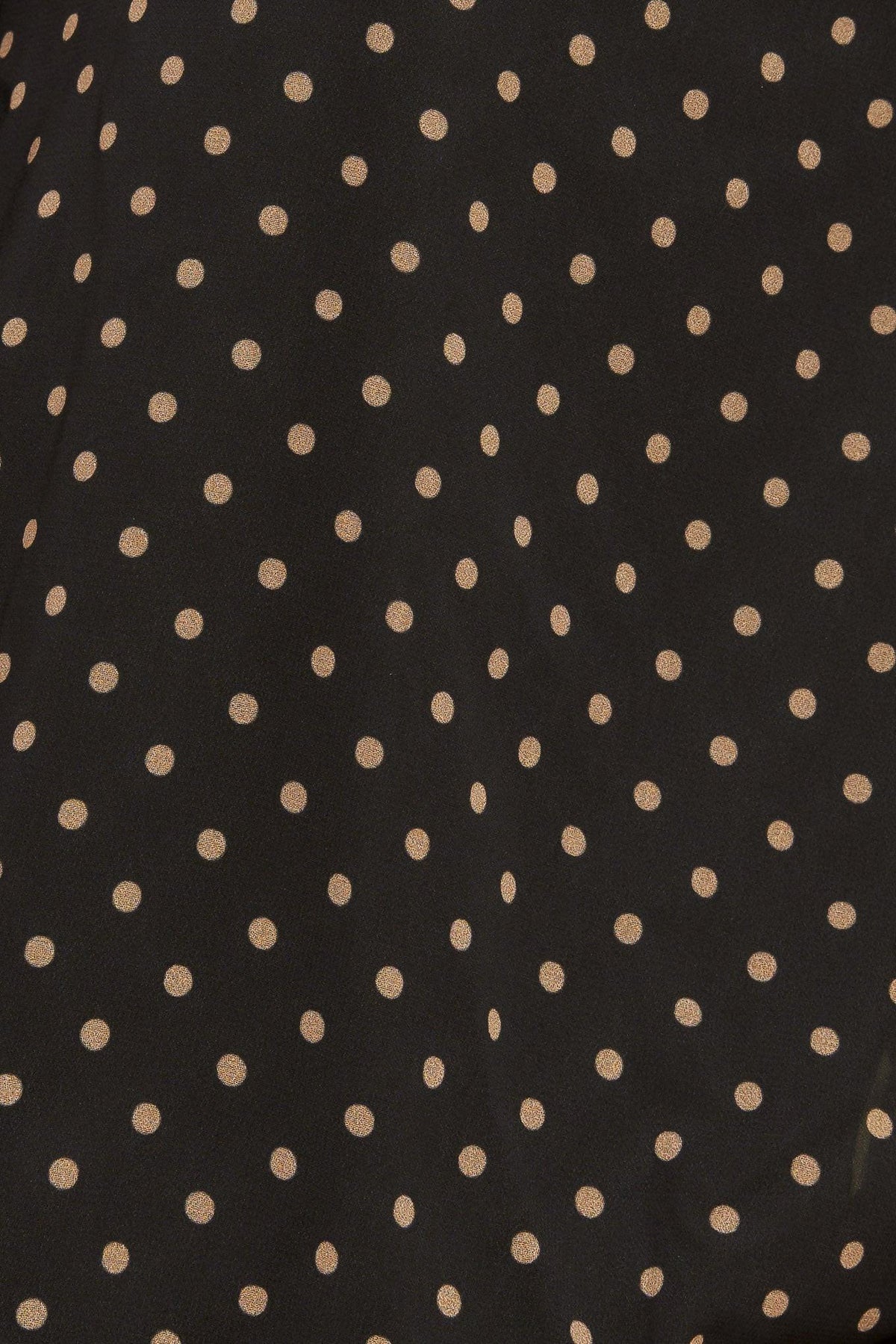 Close-up of black woven fabric with small gold dot pattern