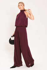 Burgundy halter woven drape top with bow-tied neckline and loose, airy drape