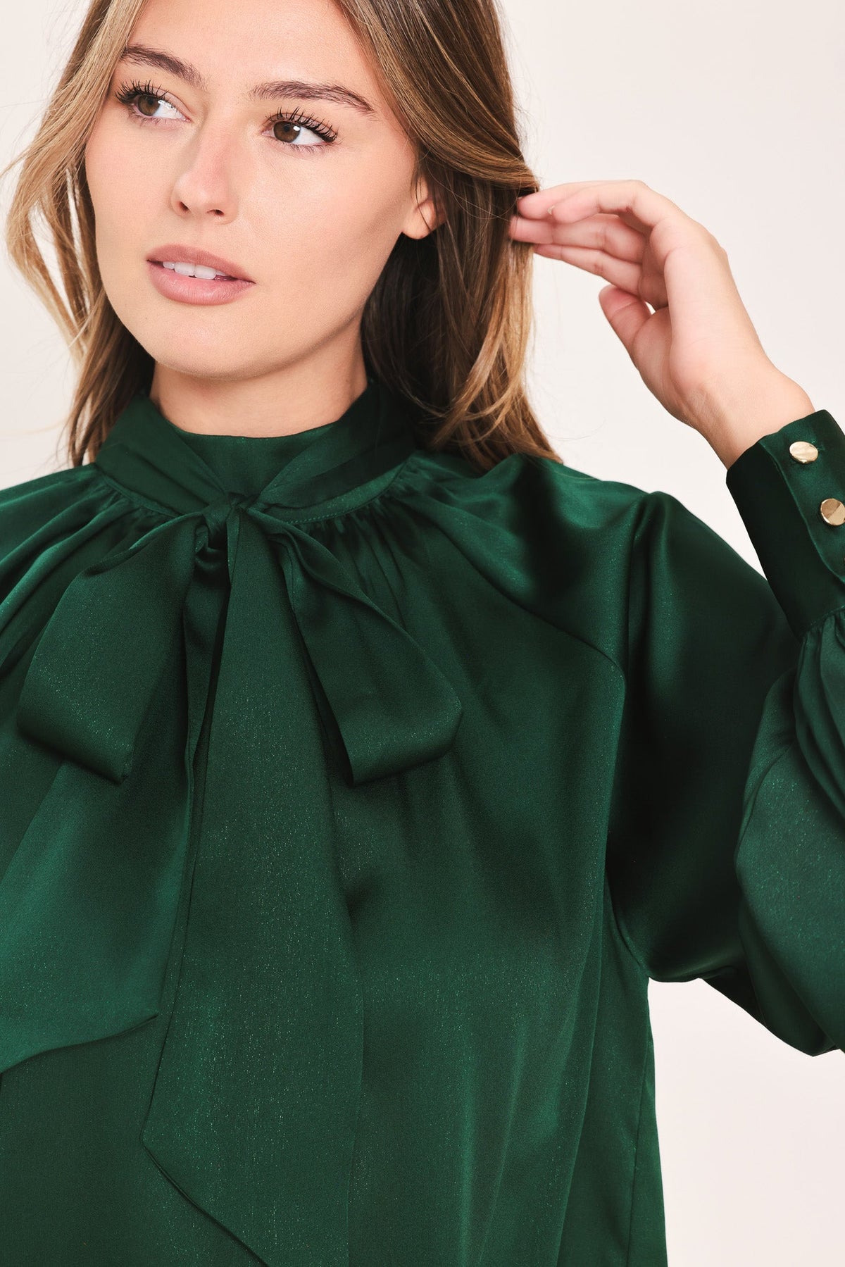 Hunter green tie-neck raglan top close-up, gathered collar bow detail