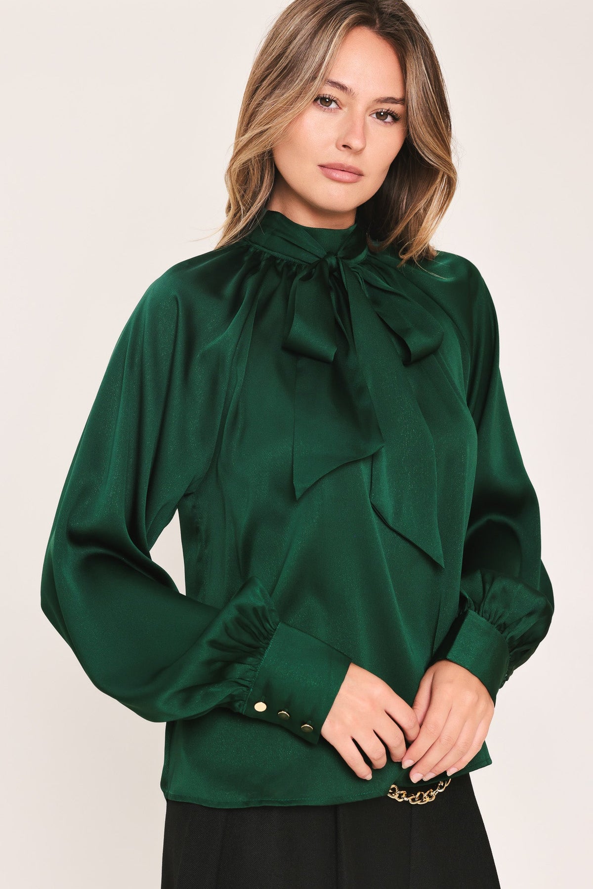 Hunter green tie-neck raglan top with long cuffed sleeves and front tie neckline