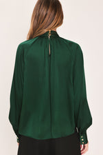 Back view of hunter green tie-neck raglan top with keyhole tie at neck