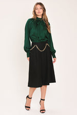 Hunter green tie-neck raglan top with bow collar and gathered cuffs
