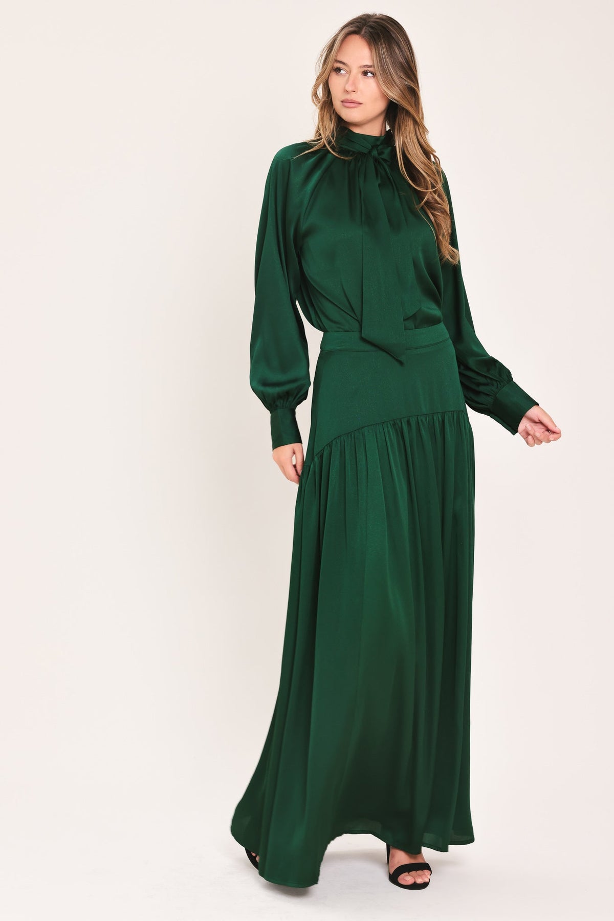 Hunter green tie-neck raglan top with bow collar and tiered peplum hem